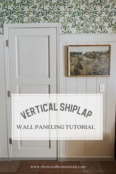 the vertical shiplap wall paneling is painted white and has green leaves on it