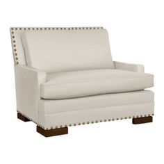 a white chair with studded arms and legs