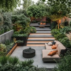 an outdoor seating area with stairs and trees in the background, surrounded by greenery