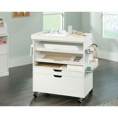 a white desk with drawers on wheels in a room