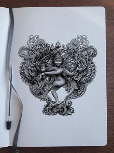 a notebook with a drawing of a woman surrounded by swirls and flowers on it