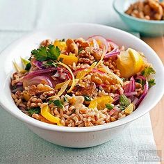 a white bowl filled with rice and vegetables