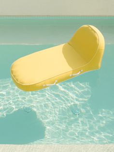 an inflatable chair floating on top of a swimming pool with clear blue water