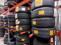 many tires are stacked up on the rack