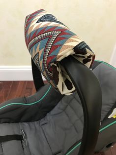 a baby car seat with a blanket on it