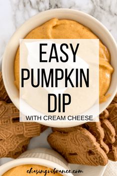 easy pumpkin dip with cream cheese in a white bowl surrounded by cookies and pretzels