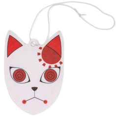 a white cat with red eyes is hanging from a string on a white wall ornament