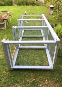 three chicken coops sitting in the grass