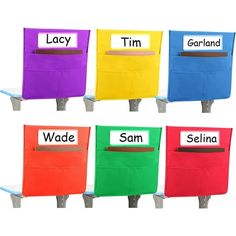 four different colored chairs with name tags on them