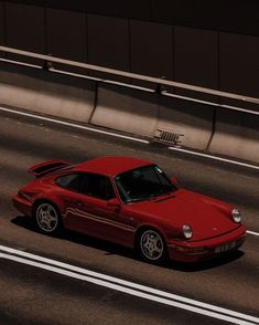 a red sports car driving down the road