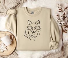 "Minimalist Line Art Fox Crewneck Sweatshirt - Unisex Comfort Fit Embrace the elegance of nature and minimalist design with our \"Minimalist Line Art Fox Crewneck Sweatshirt.\" Perfect for the modern wardrobe, this sweatshirt combines comfort, style, and ethical manufacturing to give you a garment you'll love to wear and show off. Key Features: Unisex Design: Ideal for any situation, this heavy blend crewneck sweatshirt offers pure comfort for everyone. Its unisex design ensures it fits perfectly, regardless of your style. Quality Material: Made with a medium-heavy fabric blend of 50% cotton and 50% polyester (8.0 oz/yd² (271.25 g/m this sweatshirt promises coziness during colder months. Heather Sport colors come in a 60% polyester, 40% cotton blend. Durable and Comfortable: The classic fi Art Fox, Fox Sweater, Fox Shirt, Fox Lover, Minimalist Line Art, Men Gifts, Sweater For Women, Sweater Gift, Cute Fox