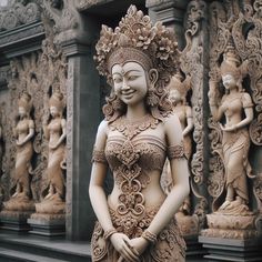 a statue of a woman standing in front of some statues