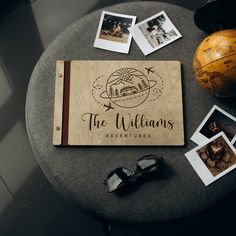 the personalized wooden notebook is surrounded by polaroid photos and an earth globe on a table