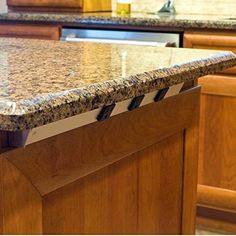 a granite counter top in a kitchen with wooden cabinets