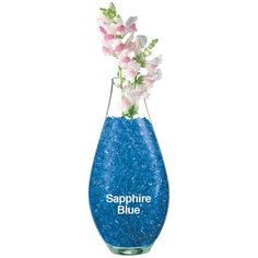 a blue vase filled with flowers on top of a white table