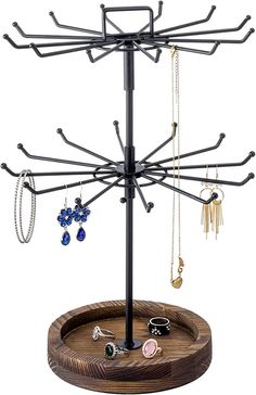 a jewelry tree with several necklaces hanging from it's sides on a wooden stand