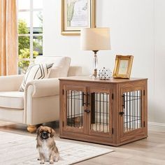 a dog is standing in the living room next to a table with a birdcage on it