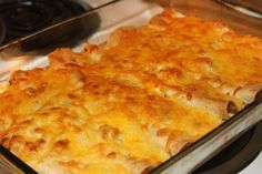 a casserole dish with cheese and meat in it sitting on the stove top