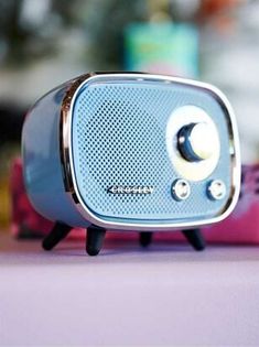 a small blue radio sitting on top of a table