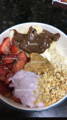 a white plate topped with different types of food on top of a black countertop