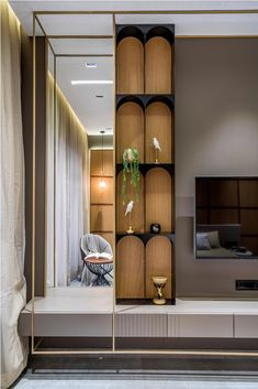 a living room with wooden shelves and a flat screen tv