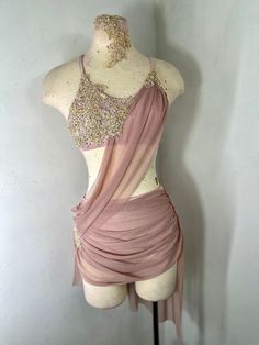 a mannequin wearing a pink dress with gold sequins on it's chest