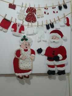 santa and mrs claus hanging on clothesline with pegs to dry out the clothes