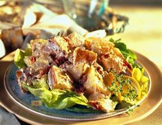 a salad with meat and lettuce on a plate