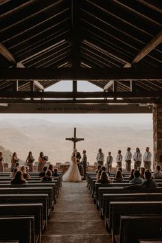 a group of people that are standing in front of some pews