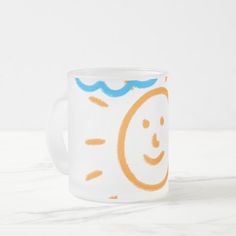 a white coffee mug with an orange and blue smiley face on the front, sitting on a marble surface