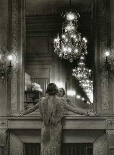 a woman standing in front of a mirror