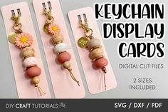 three keychain display cards with flowers and beads hanging from the front, on top of