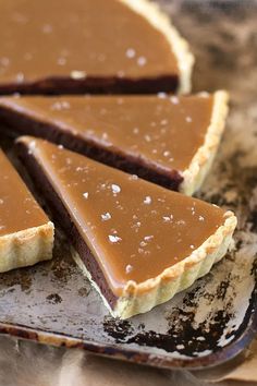 several pieces of chocolate tart sitting on top of a table