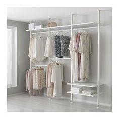 a white closet with clothes hanging on shelves