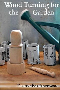 a wooden turning for the garden with rolled up newspaper rolls, hammer and pegs