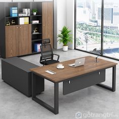 an office desk with a laptop on it in front of a bookcase and window