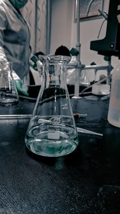 a flask filled with liquid sitting on top of a table