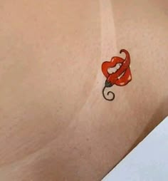 an image of a tattoo on the back of a woman's stomach that has a red umbrella attached to it