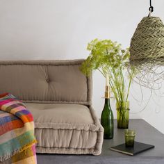 a couch and table with vases on it