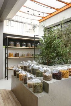 the shelves are filled with various types of spices and herbs in plastic bags next to each other