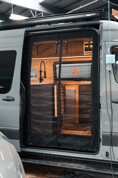 a van with its doors open in a garage