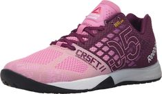 the women's crest running shoe is pink and black with white lettering on the upper part