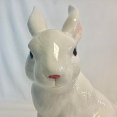 a white ceramic rabbit figurine sitting on top of a table