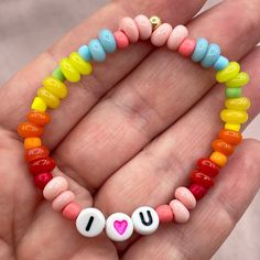 I Love You Rainbow Beaded Stretch Bracelet For Kids | Colorful Love Jewelry Gift for Children | Unisex Kids Love Bracelet  The perfect gift for a child you love! A rainbow bracelet made of vibrant glass beads, soft and smooth to the touch, with a reminder of your love, even when you're apart. All gold components are 14k gold filled.  All bracelets made in size 5.5" unless otherwise specified. If you need a different size just let me know in the section for personalization. I am dedicated to shipping your order as soon as possible. Ready to ship pieces will be sent out within 1-3 business days. Usually closer to 1 day! Custom pieces require more time to create and design. Shipping can take up to 10 days but is usually much faster. If you need your piece by a specific date or in a hurry plea Playful Rainbow Beaded Bracelets For Birthday, Personalized Playful Rainbow Bracelets, Rainbow Hand-strung Stretch Bracelet Gift, Valentine's Day Heart-shaped Stretch Bracelet With Colorful Beads, Valentine's Day Heart-shaped Colorful Bead Stretch Bracelet, Bracelet For Kids, Bracelet Love, Love Jewelry, Love Bracelet