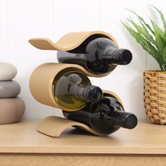 two bottles of wine sitting on top of a wooden stand