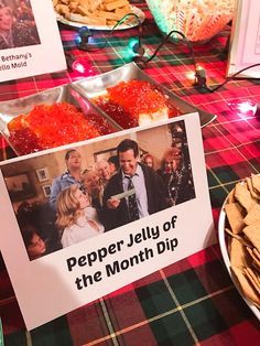 there is a sign that says pepper jelly of the month dip next to crackers