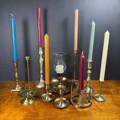 an assortment of candles on a wooden table