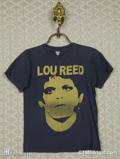 a t - shirt that says lou reed on the front and yellow print on the back