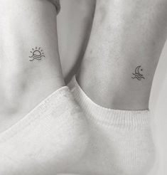 two small sun and moon tattoos on their legs, both with the same tattoo design