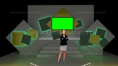 a woman is standing in front of a stage with green screens on the wall and stairs